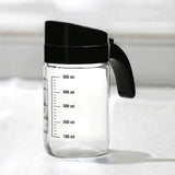 Transparent 660 ml Glass Oil Measure Jar With Lid (Transparent & Black)