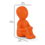 Boy Sitting with Folded Legs Polyresin Decorative Showpiece (Orange)